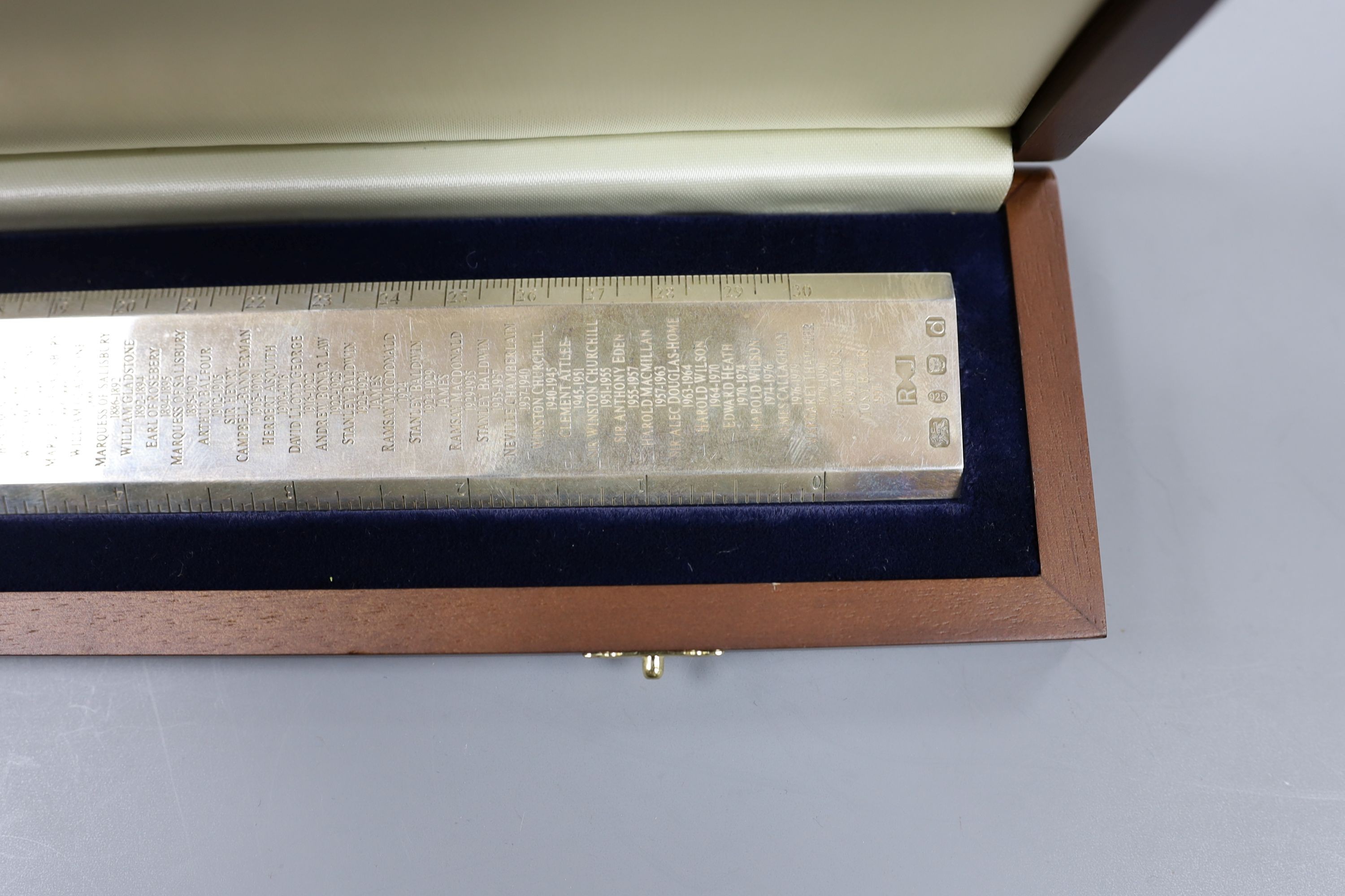 A cased modern silver 'Premier Rule' ruler, engraved with the names and dates of British Prime ministers, by Richard Jarvis, London, 2003, 10oz.